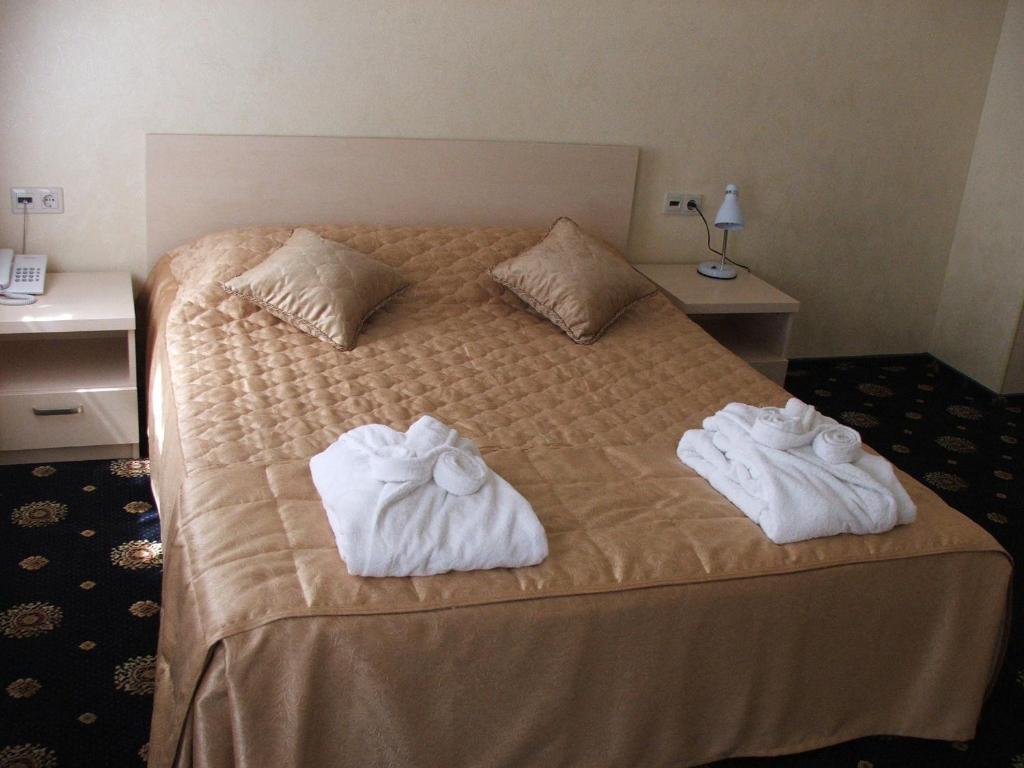 Postel nebo postele na pokoji v ubytování Gonchar Hotel