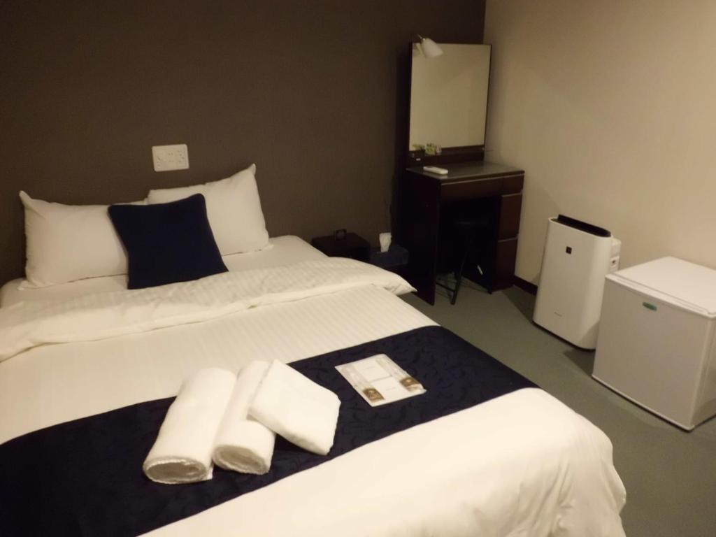 Postel nebo postele na pokoji v ubytování Sumiya Spa & Hotel