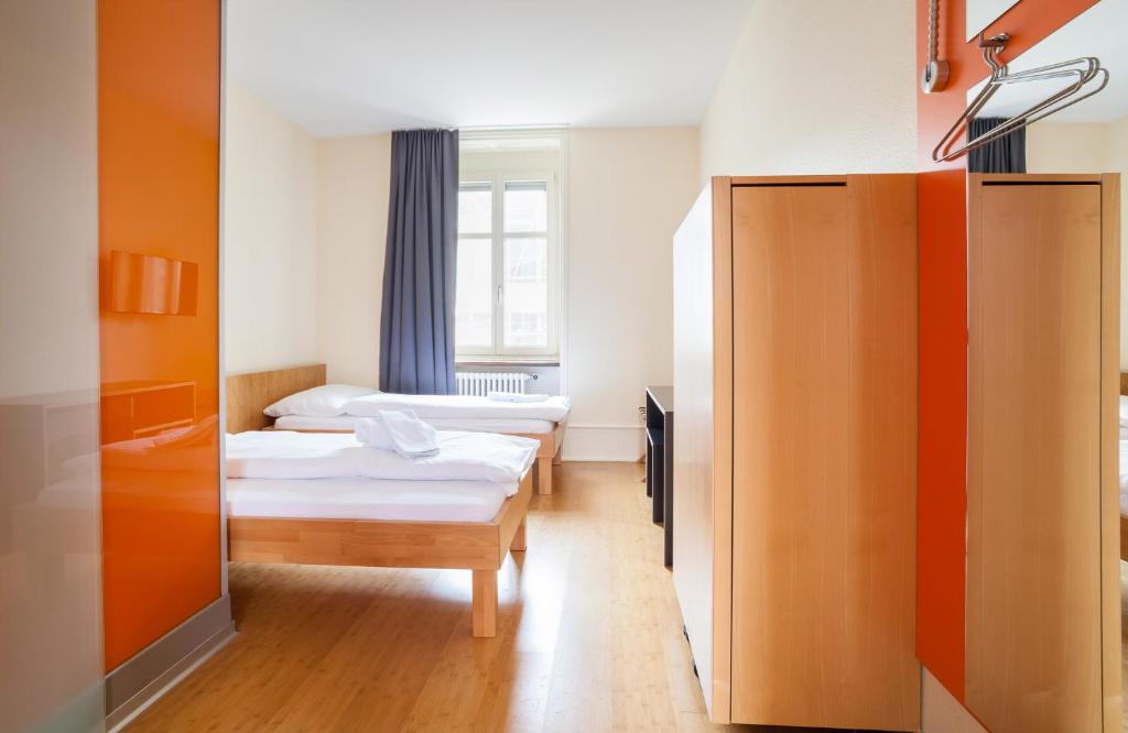 a room with two beds and a window at easyHotel Basel City - contactless self check-in in Basel