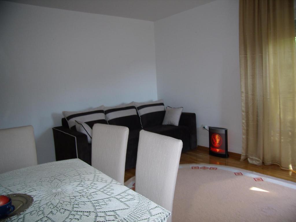 a living room with a table and chairs and a couch at Panorama 5 in Soko Banja