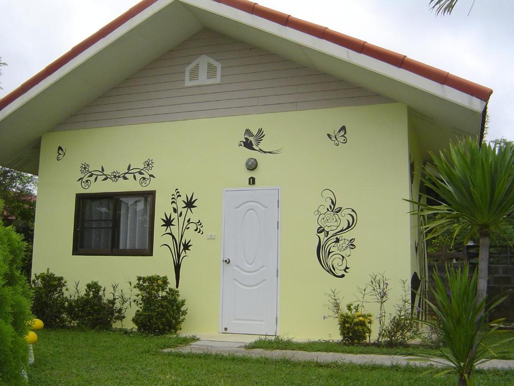 a small house with butterflies painted on the side of it at Mini-golf **** & Resort Ubon Ratchathani in Ubon Ratchathani