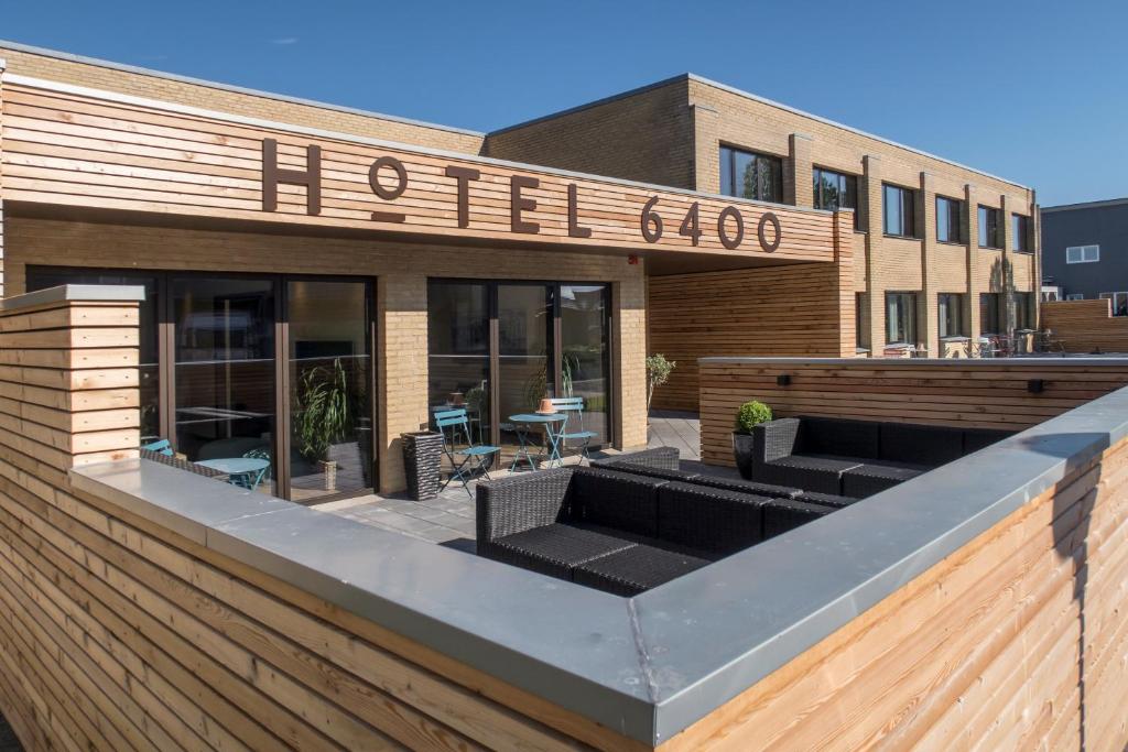 a hotel with couches in front of a building at Hotel 6400 in Sønderborg