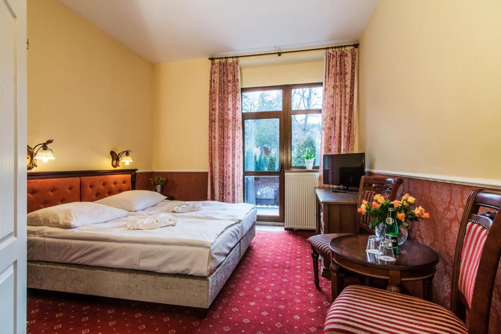 Postel nebo postele na pokoji v ubytování Perła Karkonoszy SPA - W samym centrum Karpacza