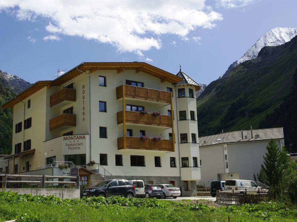 a building with cars parked in front of it at Hotel Montana in Solda