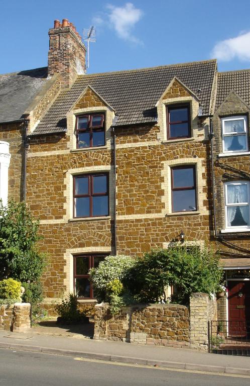 a brick house on the side of a street at Honeycomb House Apartments in Hunstanton