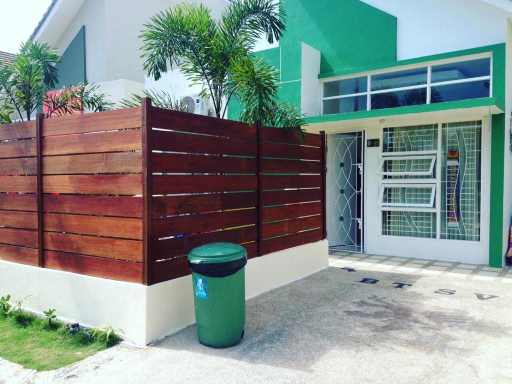 a fence in front of a house with a trash can at Fullhouse in Mataram