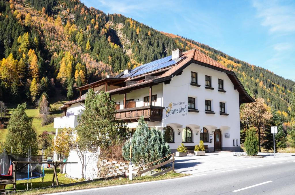a large white building on the side of a mountain at Sonnenhof - Apartments & Zimmer in Kaunertal