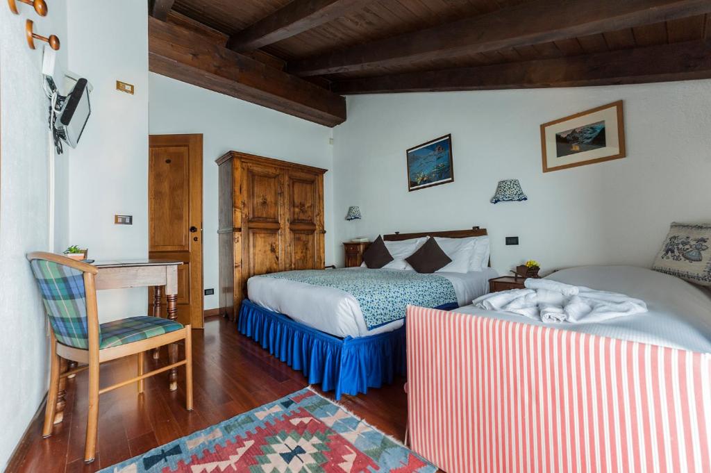 Postel nebo postele na pokoji v ubytování Hotel Baita Cretaz