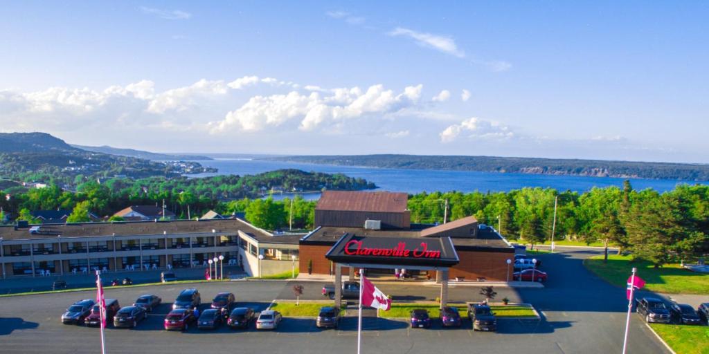 a hotel with cars parked in a parking lot at Clarenville Inn in Clarenville