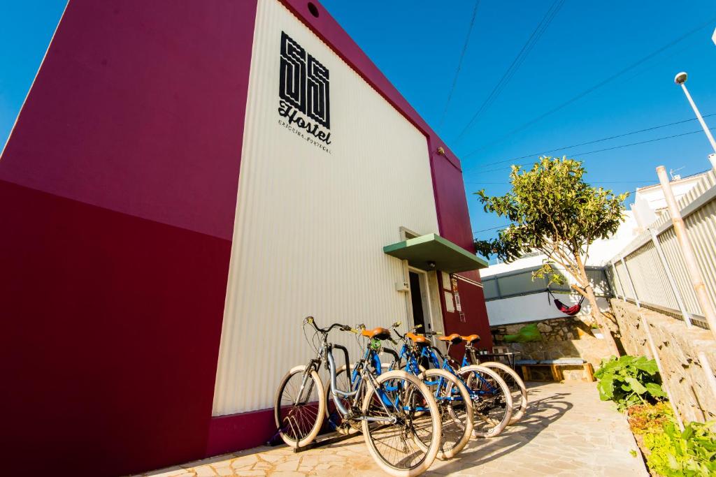 a group of bikes parked on the side of a building at Hostel & Surfcamp 55 in Ericeira