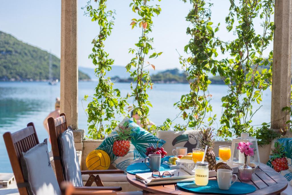 a dining table with a view of the water at Nono Frano in Prožura