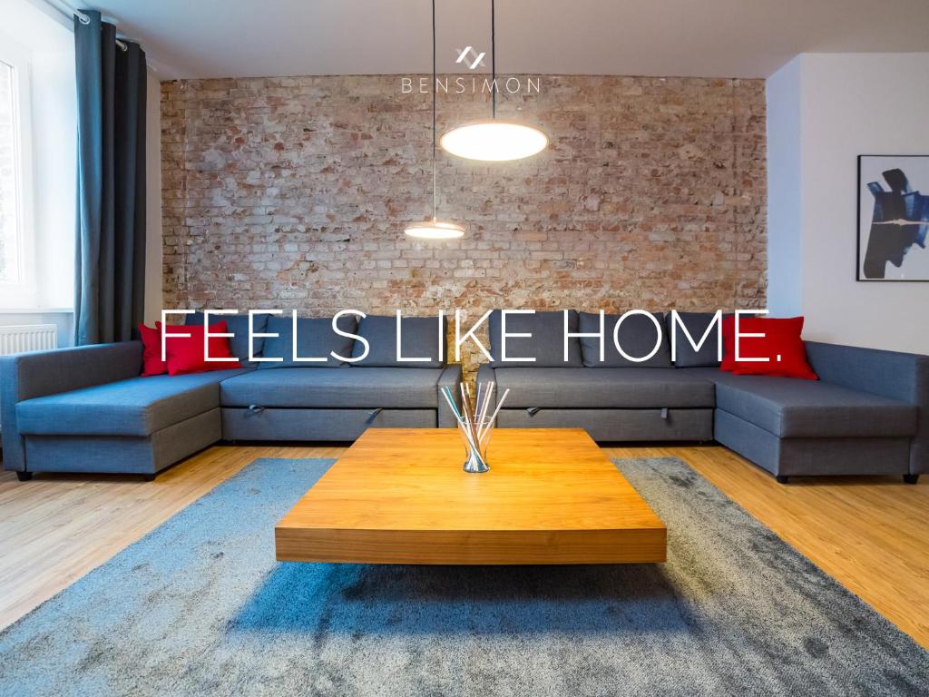 a living room with a couch and a table at BENSIMON apartments Mitte - Moabit in Berlin