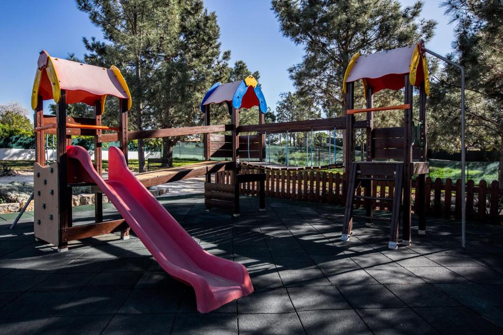 a playground with a slide in a park at Vale d'El Rei Hotel & Villas in Carvoeiro