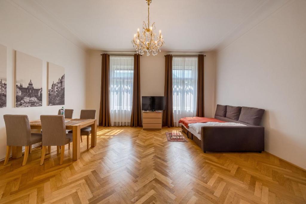 a living room with a bed and a dining room at Apartments 39 Wenceslas Square in Prague