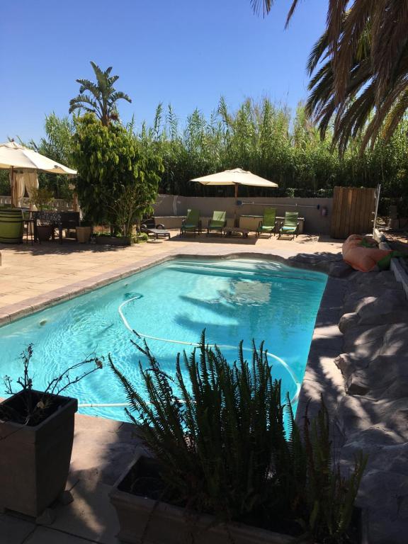 a swimming pool with blue water in a yard at Ons Stee Bed and Breakfast in Wellington