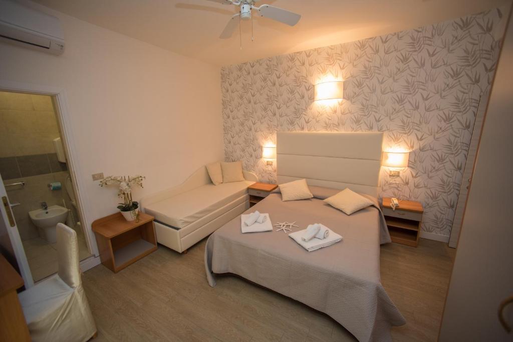 Postel nebo postele na pokoji v ubytování Hotel Ermeti B&B Brunch