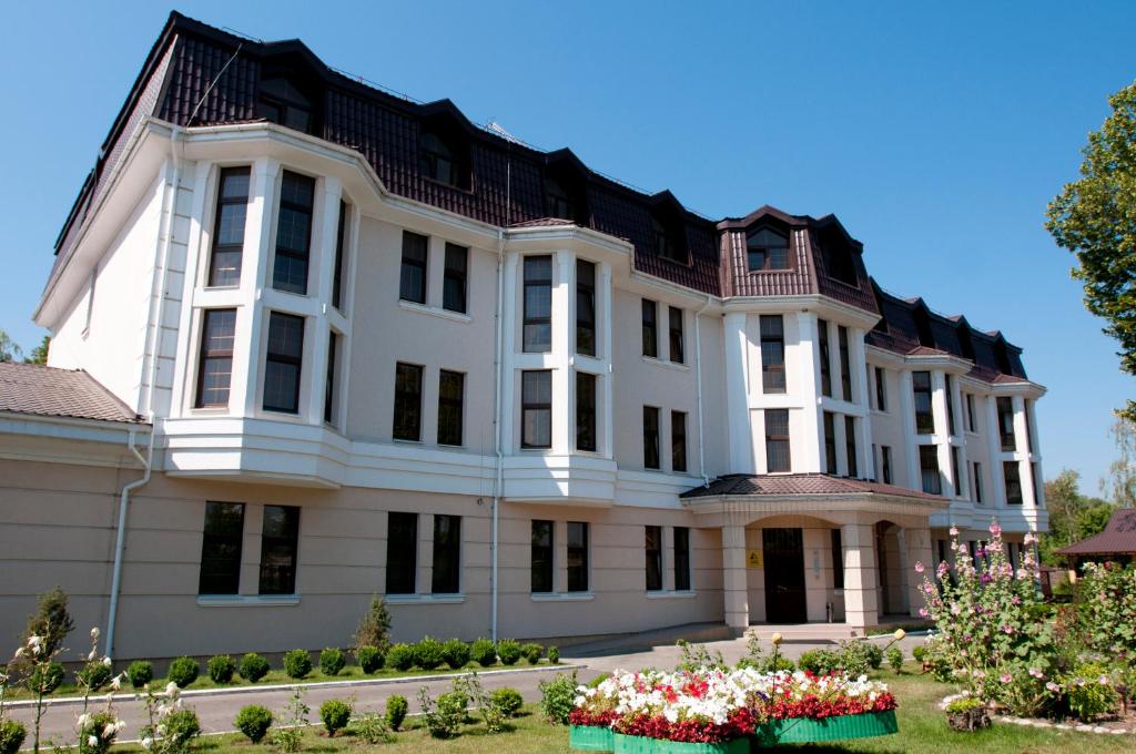 a large brick building with a large window at Ligena Hotel in Boryspil