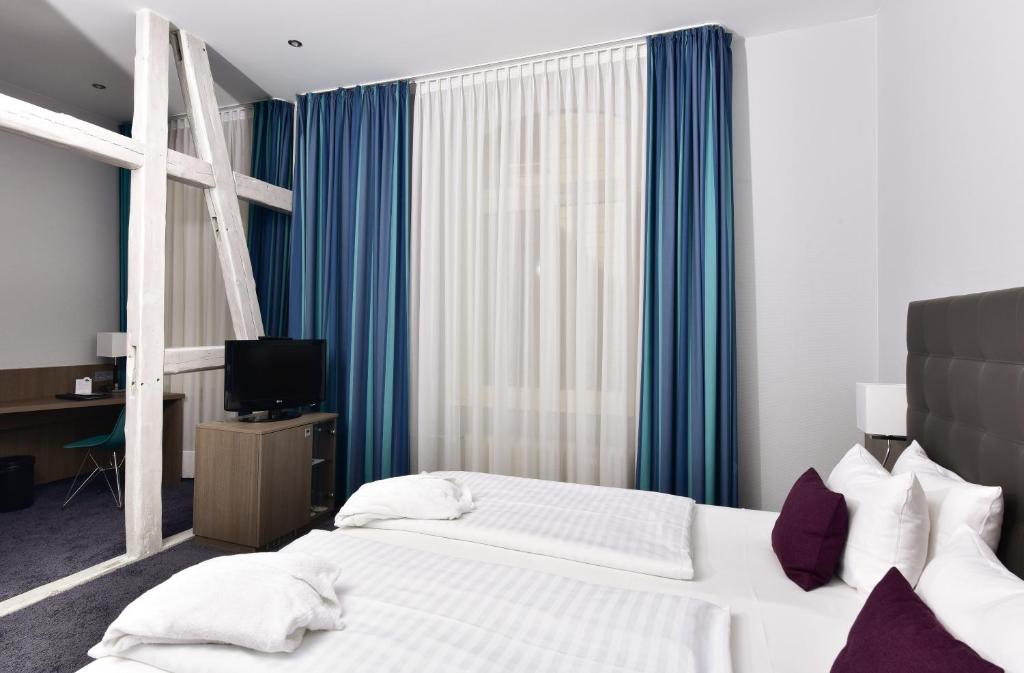 Postel nebo postele na pokoji v ubytování Frühlings-Hotel