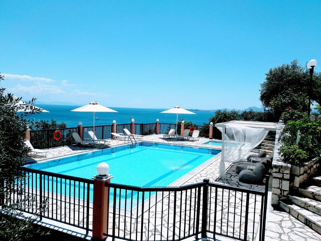 a swimming pool with a view of the ocean at Villa Nestoras in Nisaki
