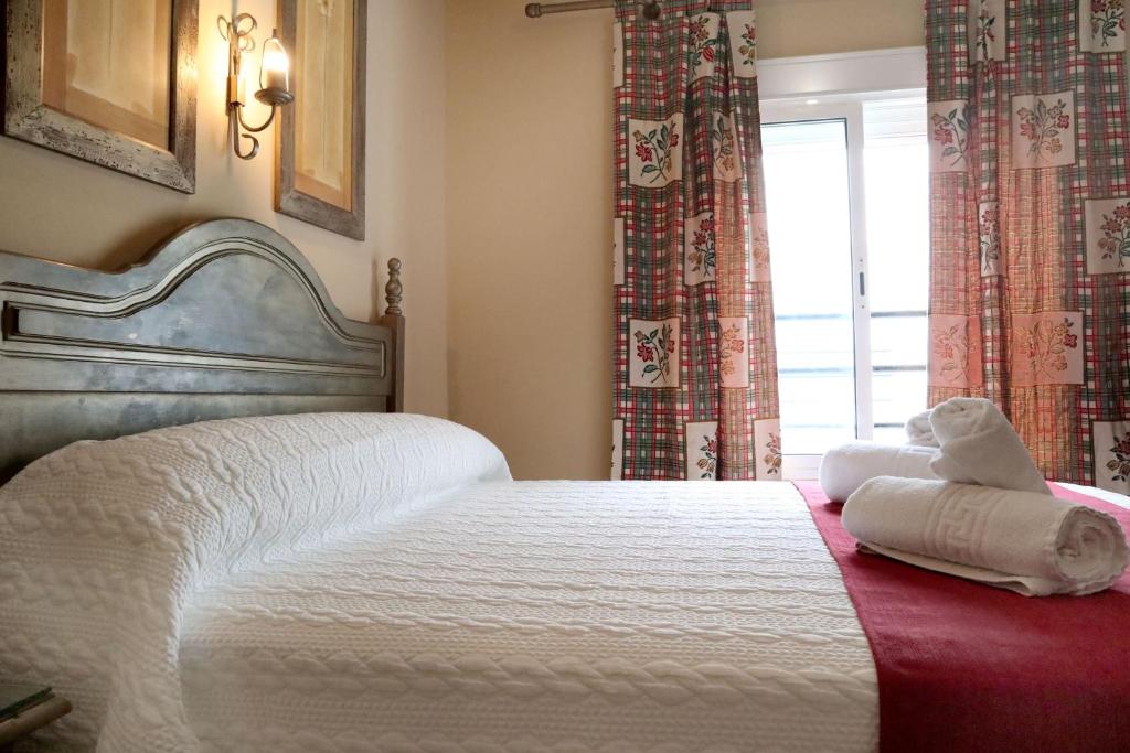Łóżko lub łóżka w pokoju w obiekcie Hostal Victoria