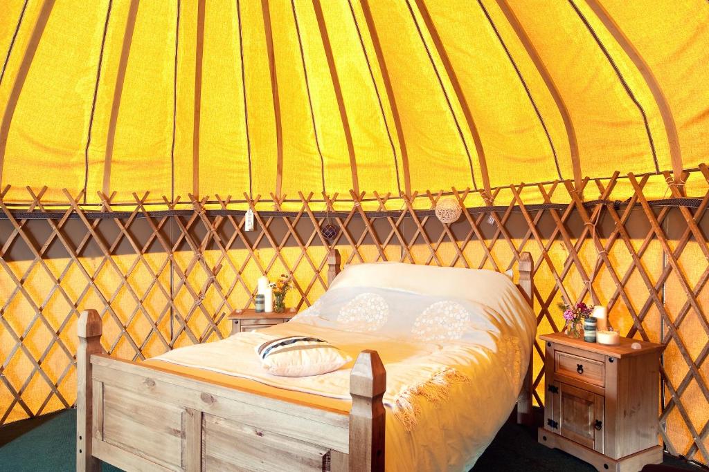 a bedroom with a bed in a yurt at Portsalon Luxury Camping in Portsalon