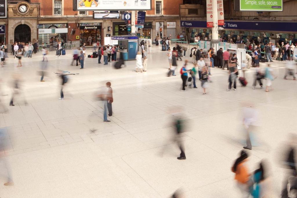 a crowd of people walking in a shopping mall at The Z Hotel Victoria in London