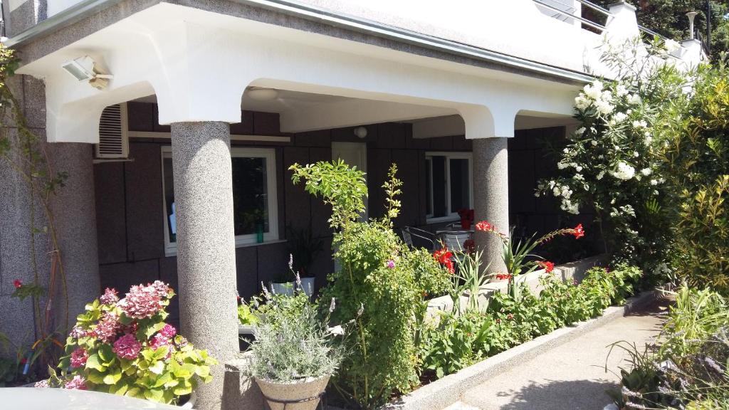a front porch with flowers and plants at Apartment Melany in Senj