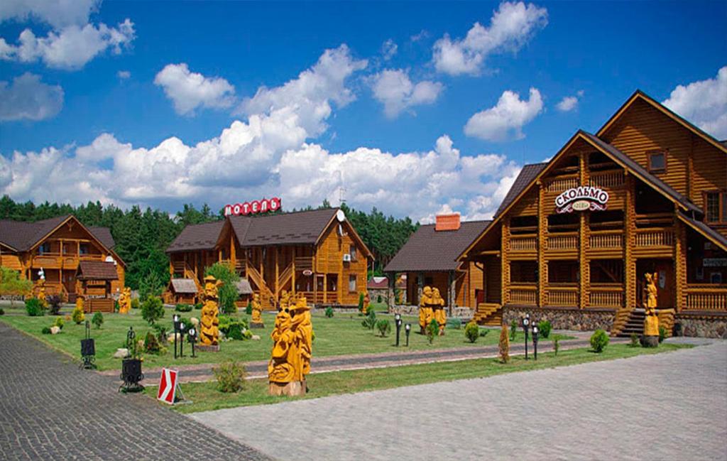 a model of a resort with a tiger statue in front of buildings at Hotel and restaurant complex Skolmo in Klevanʼ