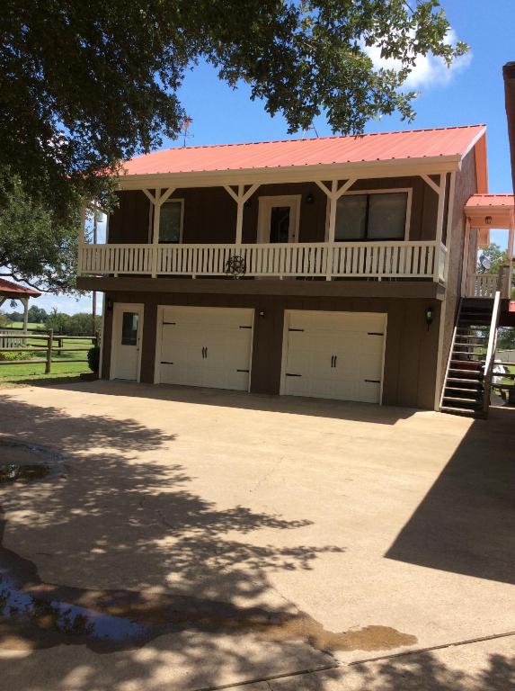 a house with a balcony and two garage at The Carriage House of Canton in Canton