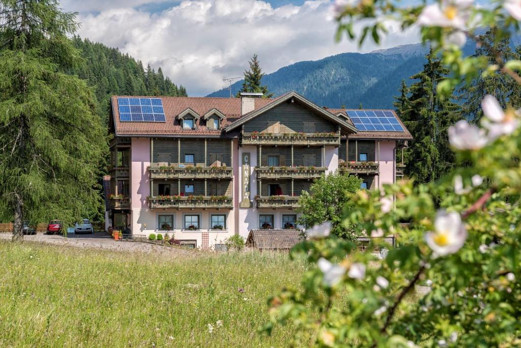 a house with solar panels on the roof at Hotel Canada in Predazzo