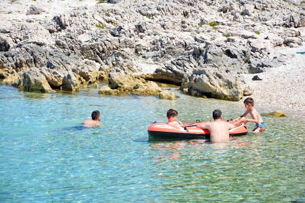 a group of people in the water in a raft at Apartments Marta in Verunić