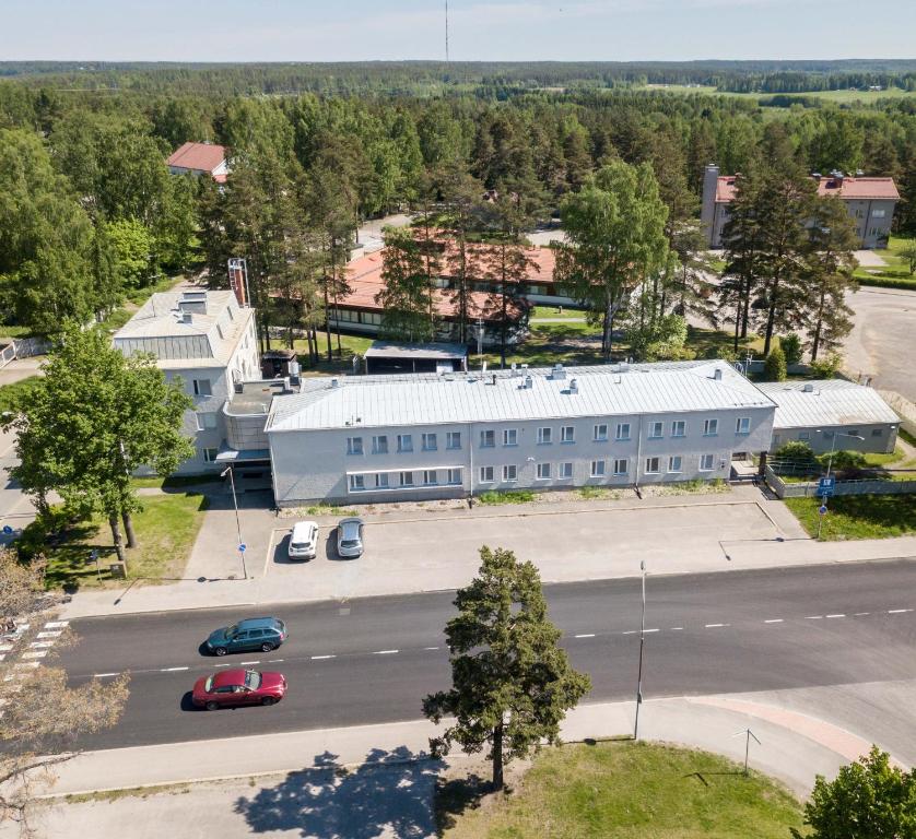 an aerial view of a large white building with a parking lot at Gasthaus Patruuna in Joutseno