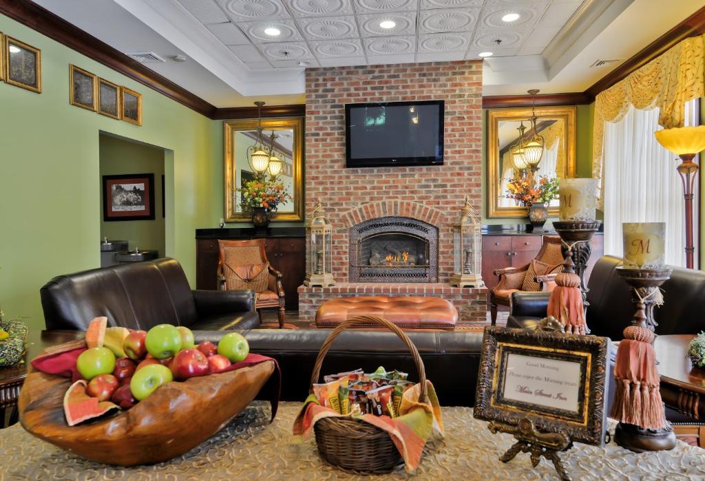 a living room with a couch and a fireplace at Main Street Inn Blacksburg in Blacksburg