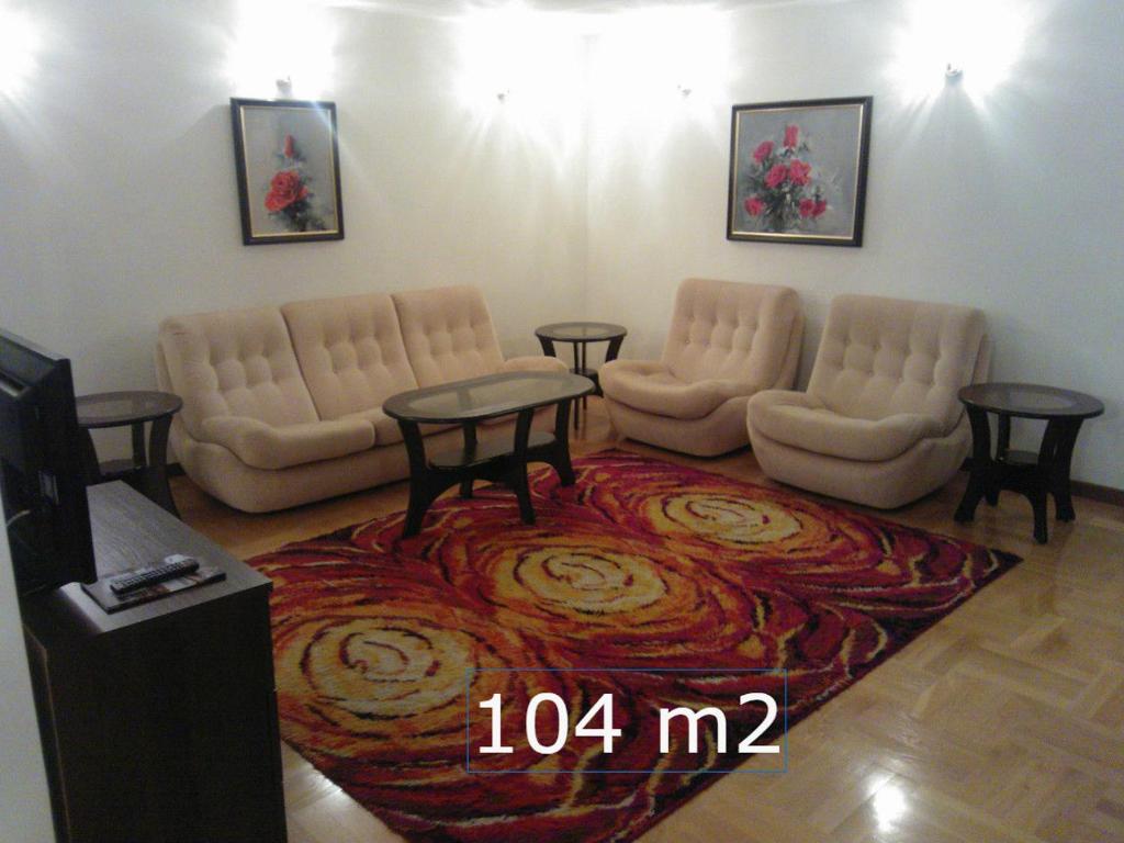 a living room with two chairs and a table at Apartment Nowiniarska near the Old Town in Warsaw