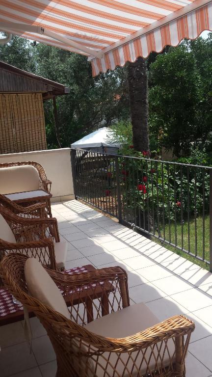 a patio with chairs and a table and a fence at Apartment Pijer in Novalja