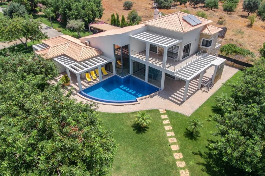an aerial view of a house with a swimming pool at Family Country House in Faro