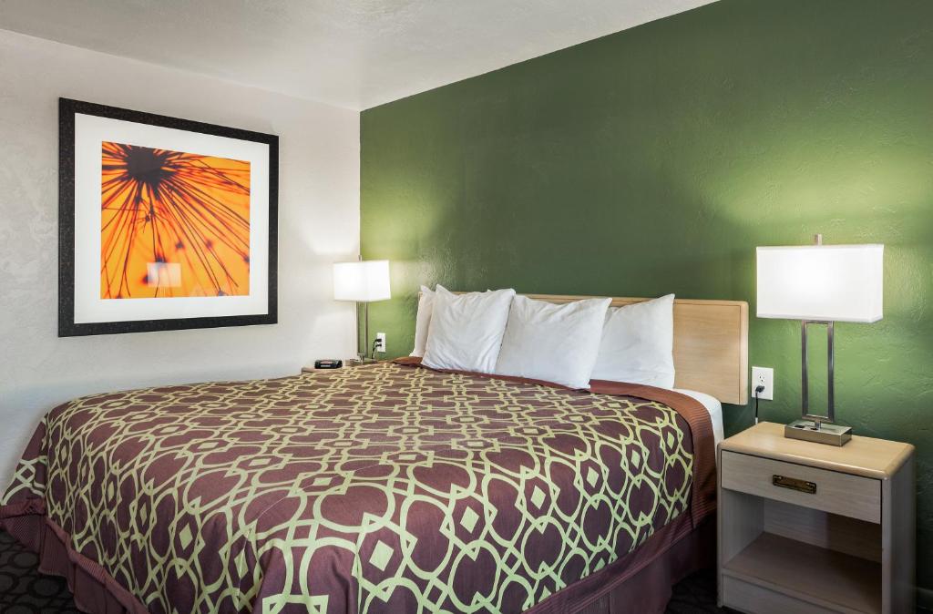 a hotel room with a bed and a painting on the wall at Downtown Inn in Eugene