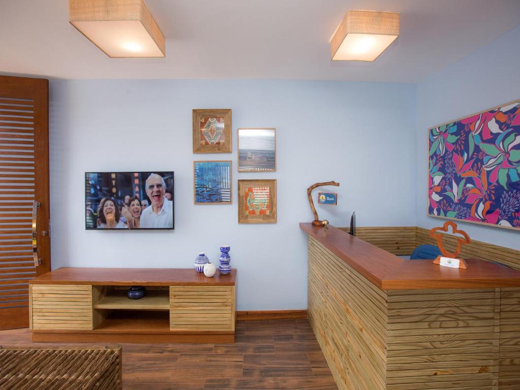 a room with a desk and a table and a room at Pousada Paraíso do Forte in Praia do Forte