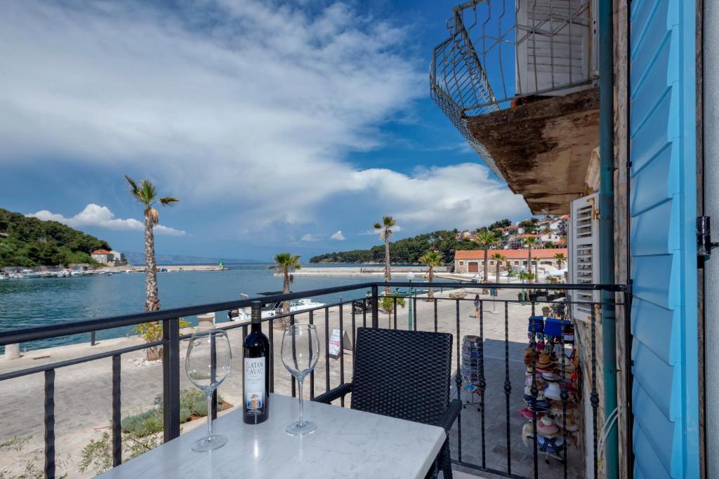 a balcony with a table and a view of the beach at Villa Riva in Jelsa