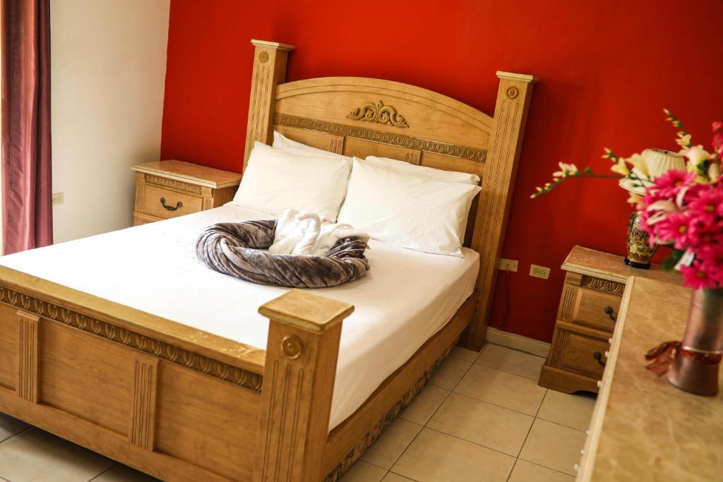 a bedroom with a bed with a wooden bed frame at Winchester Sunshine in Kingston