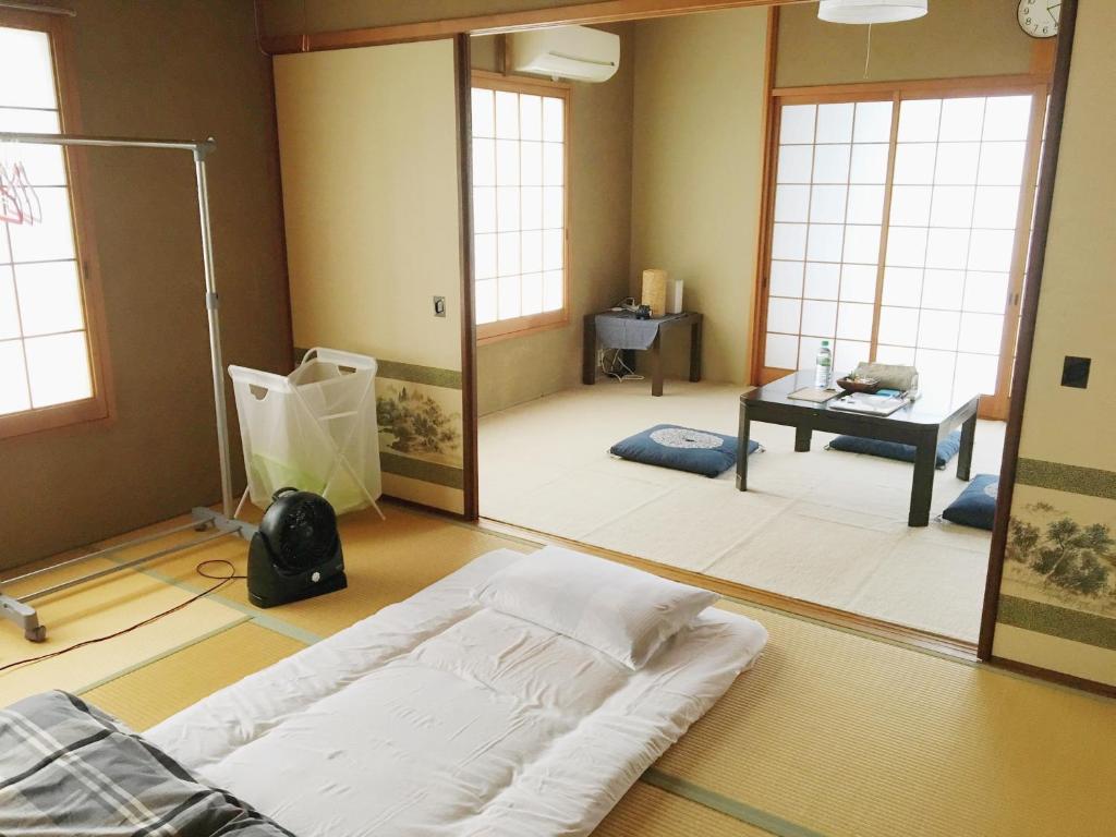 een kamer met een bed en een grote spiegel bij Guesthouse Ogawaya in Tanabe