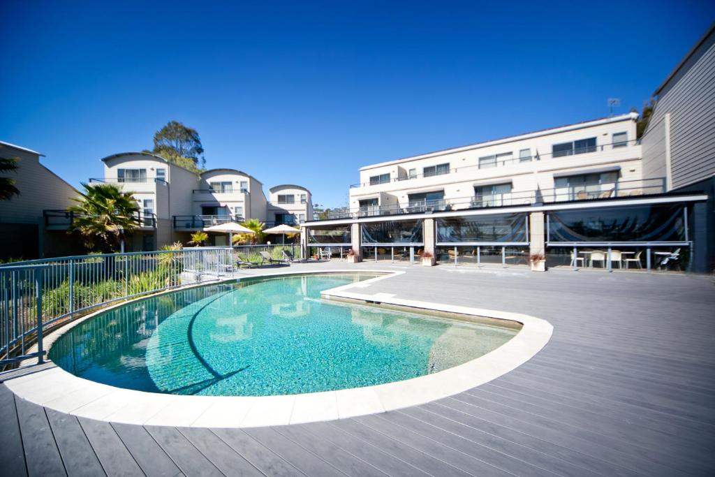 a swimming pool in front of a building at Corrigans Cove in Batemans Bay