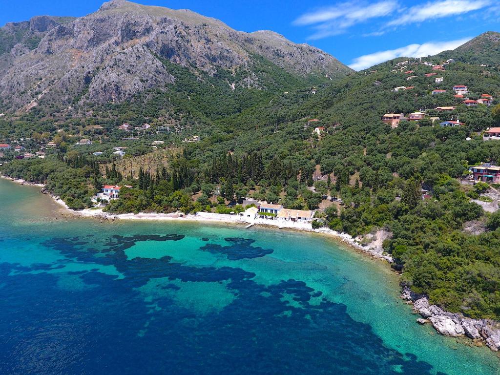 an aerial view of a beach with blue water at Nissaki Olive Press Villas in Nisakion