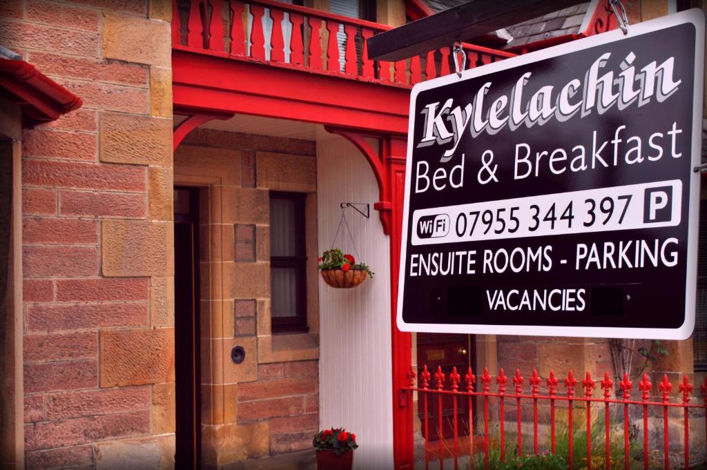 a sign for a bed and breakfast on the side of a building at Kylelachin in Dingwall