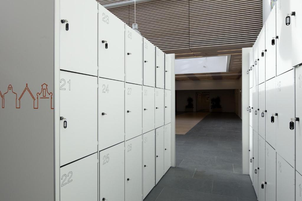 a hallway with white lockers in a building at easyHotel Amsterdam Zaandam in Zaandam