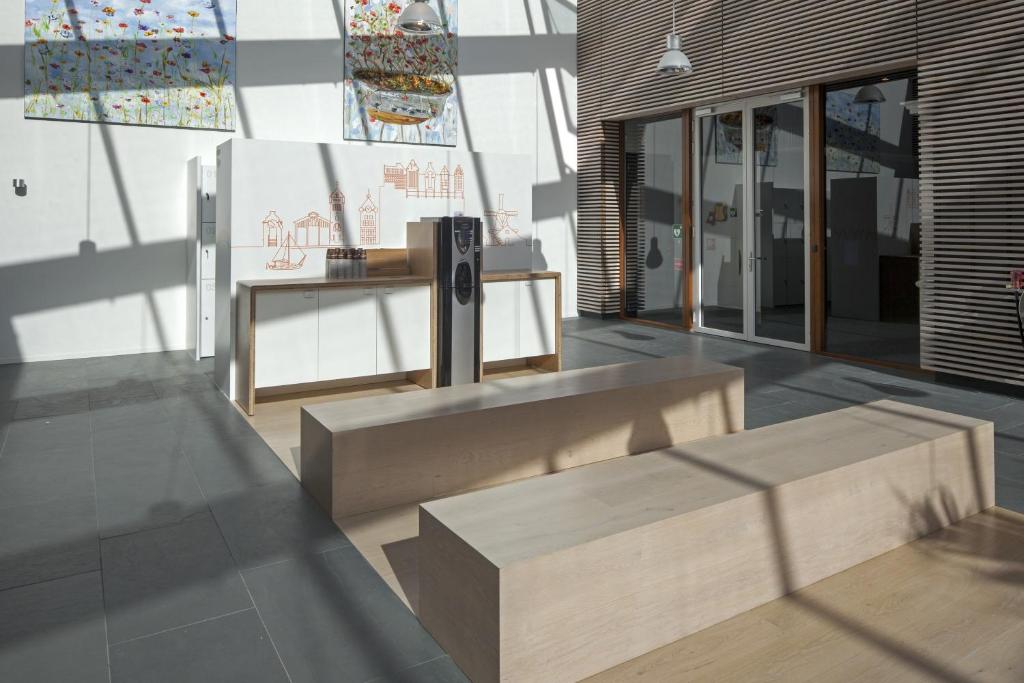 a room with benches and a table in a building at easyHotel Amsterdam Zaandam in Zaandam