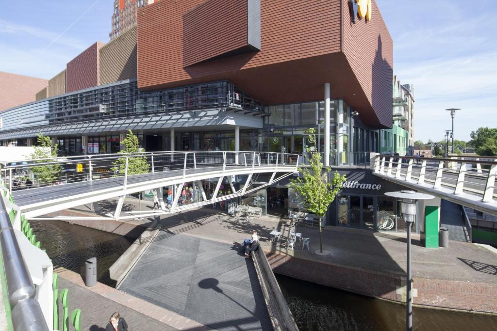 a bridge over a river in front of a building at easyHotel Amsterdam Zaandam in Zaandam