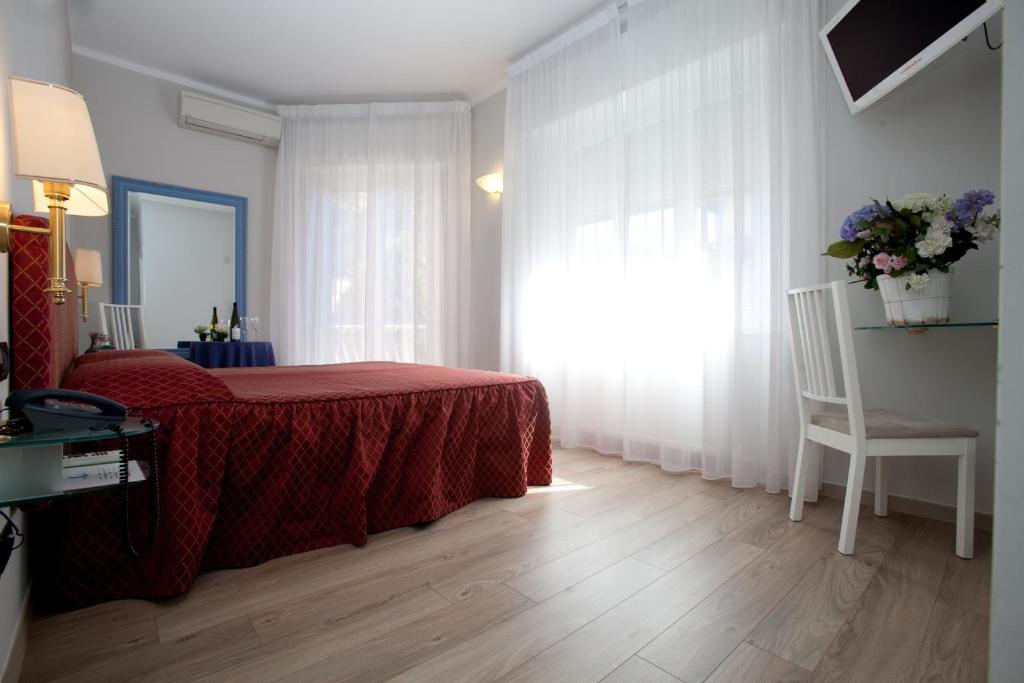Postel nebo postele na pokoji v ubytování Hotel Il Gatto