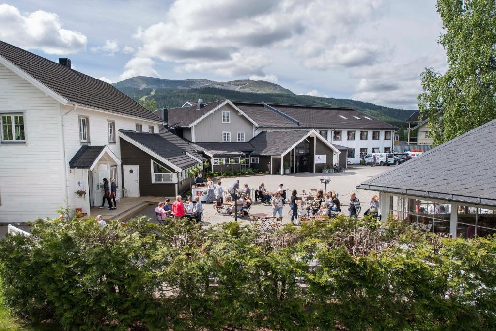 a group of people standing in a courtyard in a village at Trysil Hotel in Trysil