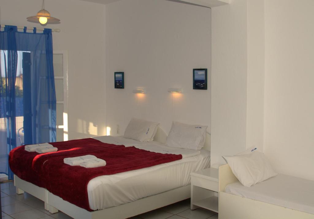 ミラトスにあるPorto Bello Hotel Apartmentsの白いベッドルーム(ベッド1台、ソファ付)
